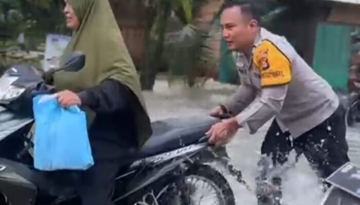 Banjir Meluap ke Jalan, Personil Polsek Tungkal Jaya Bantu Pengendara